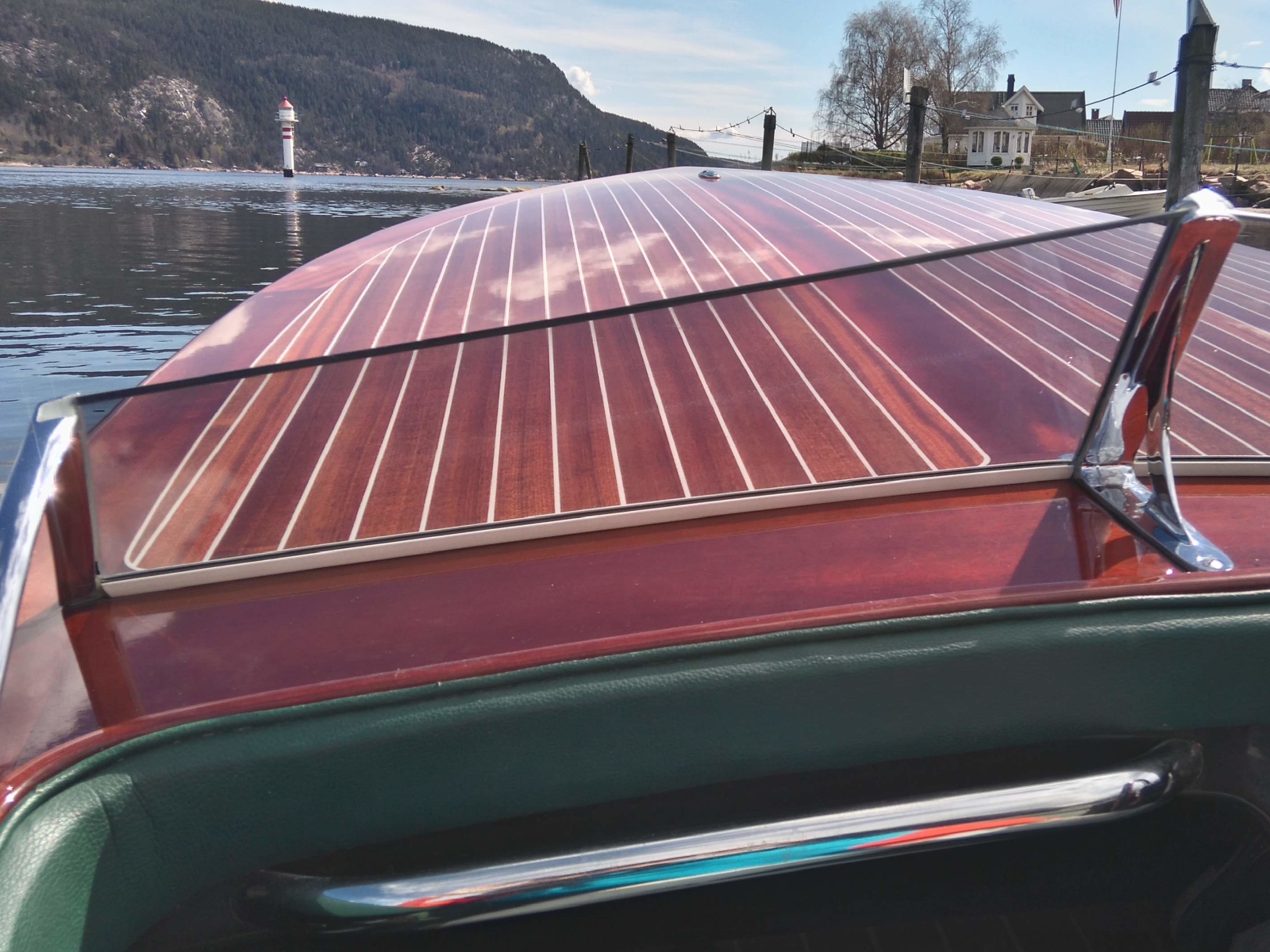 Restored classic wooden speedboat on the water with high-gloss deck
